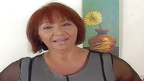 A hot brunette with big tits masturbates on the bed