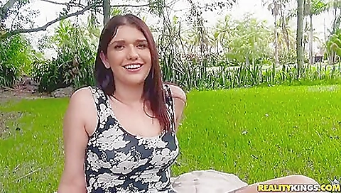 Brunette girl rides her bike with her man in the park