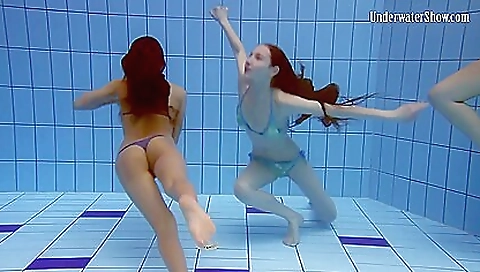 Two busty brunette girls in the pool do lesbian threesome
