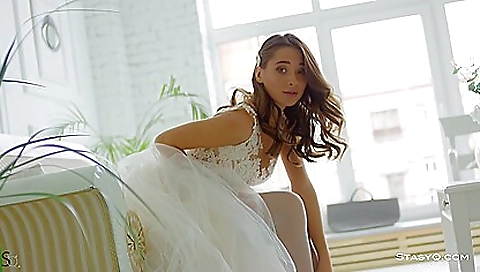 Slutty brunette in stockings and sexy dress plays with her tits