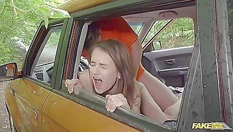 Brunette teen gives a blowjob in the car with her boyfriend